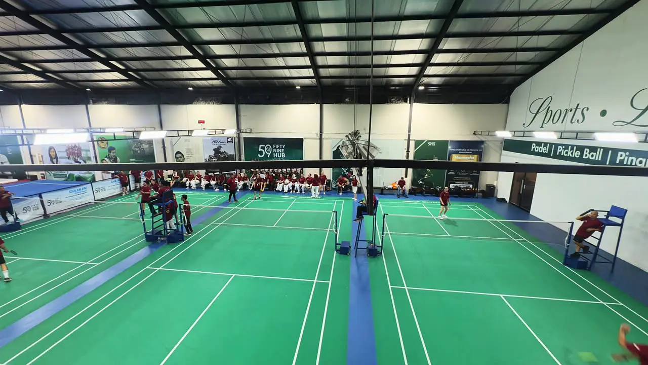 Badminton court: Tiga court indoor berkarpet hijau